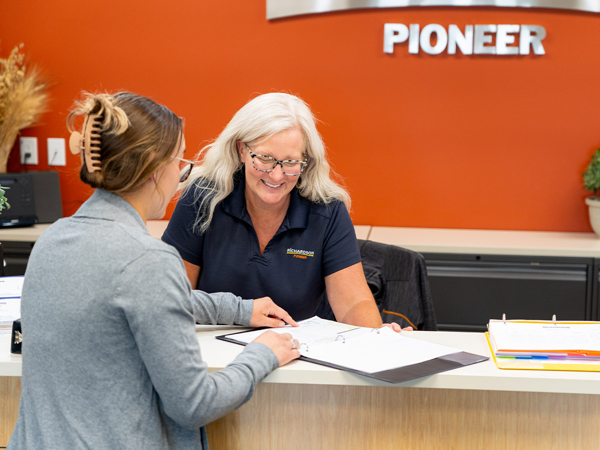 Richardson Pioneer Employee Reviewing Documents with Customer